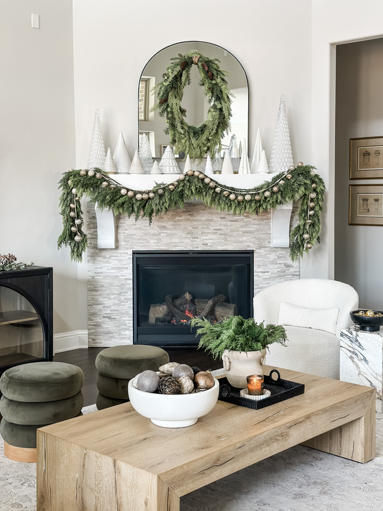 home for the holidays decor round up | holiday, holiday home, holiday home tour, holiday mantle, mantle styling, wreath, holiday table, Christmas, garland, ornament garland, tufted ottoman