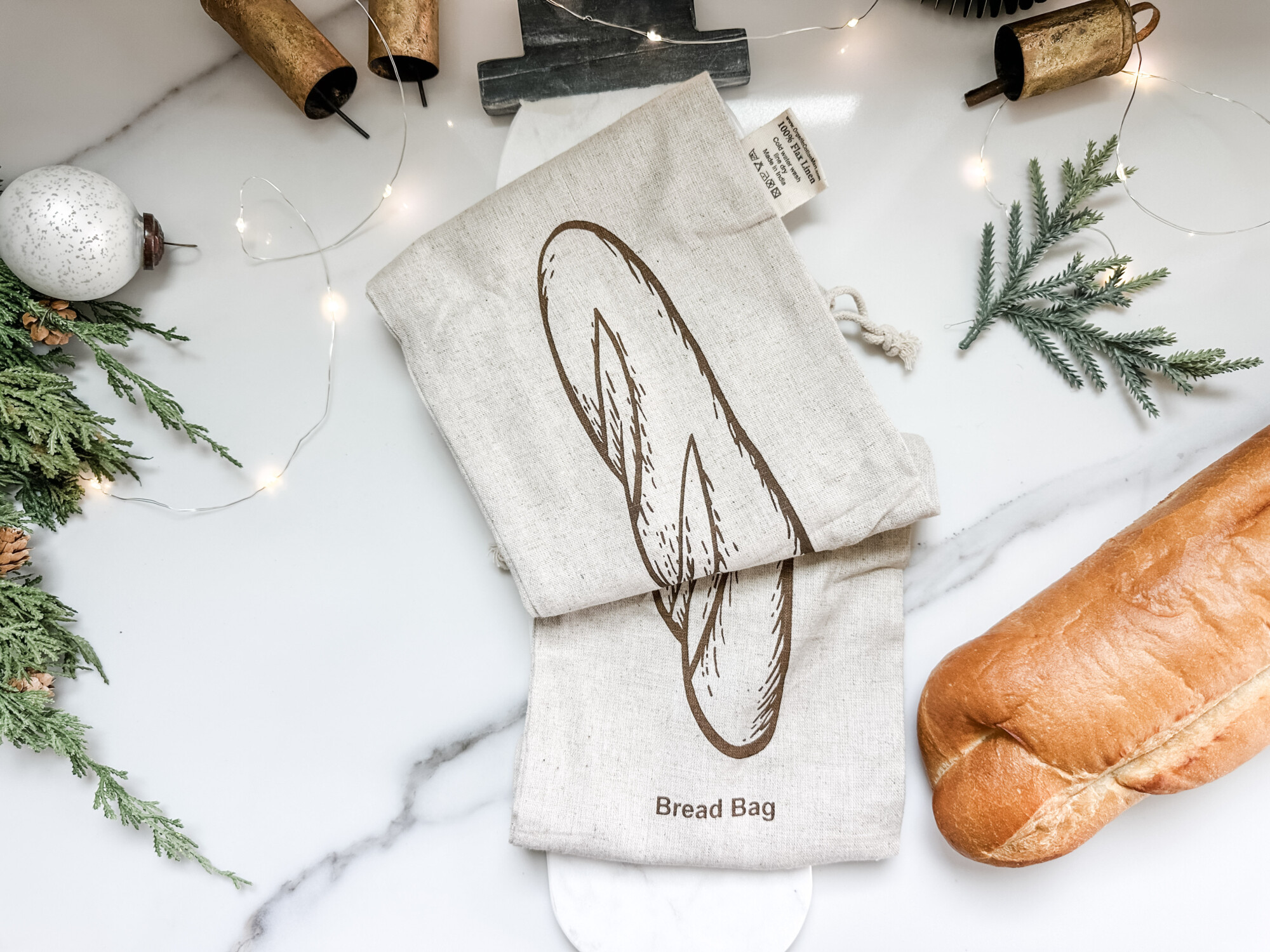 thoughtful and affordable diy host gifts under $35 | host gifts, diy gifts, gift ideas, handmade gift, gift ideas, bread, loaf, marble snowman, cute snowman, snowman decor, cheap bread bag, christmas kitchen