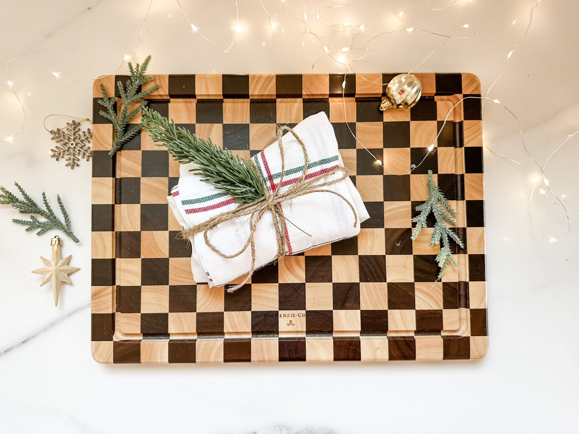 thoughtful and affordable diy host gifts under $35 | host gifts, diy gifts, gift ideas, handmade gift, gift ideas, carving board, twine, holiday greenery, ornaments, tea towel
