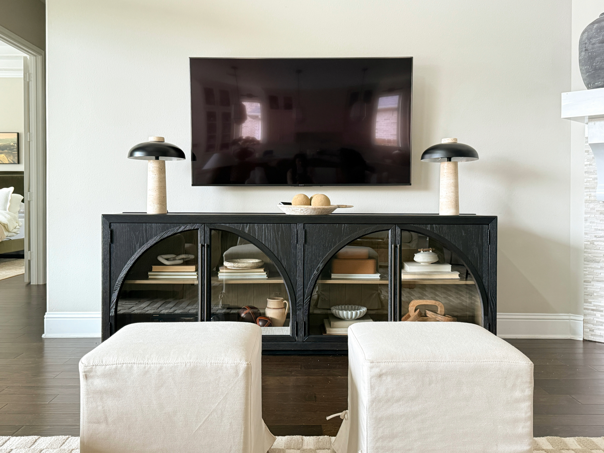arhaus sideboard media cabinet in black and mid century modern stone lamps
