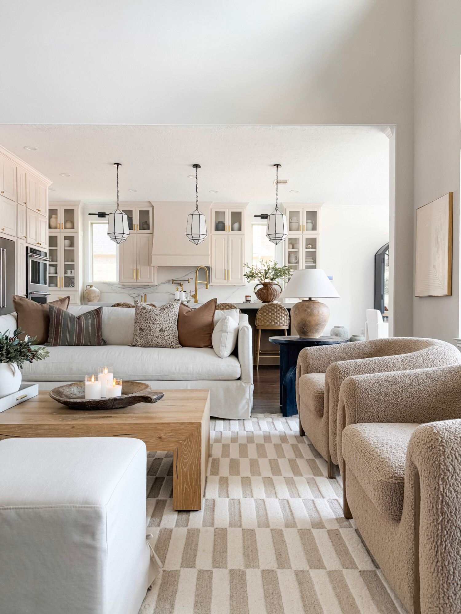 beige living room with teddy chairs and white sofa