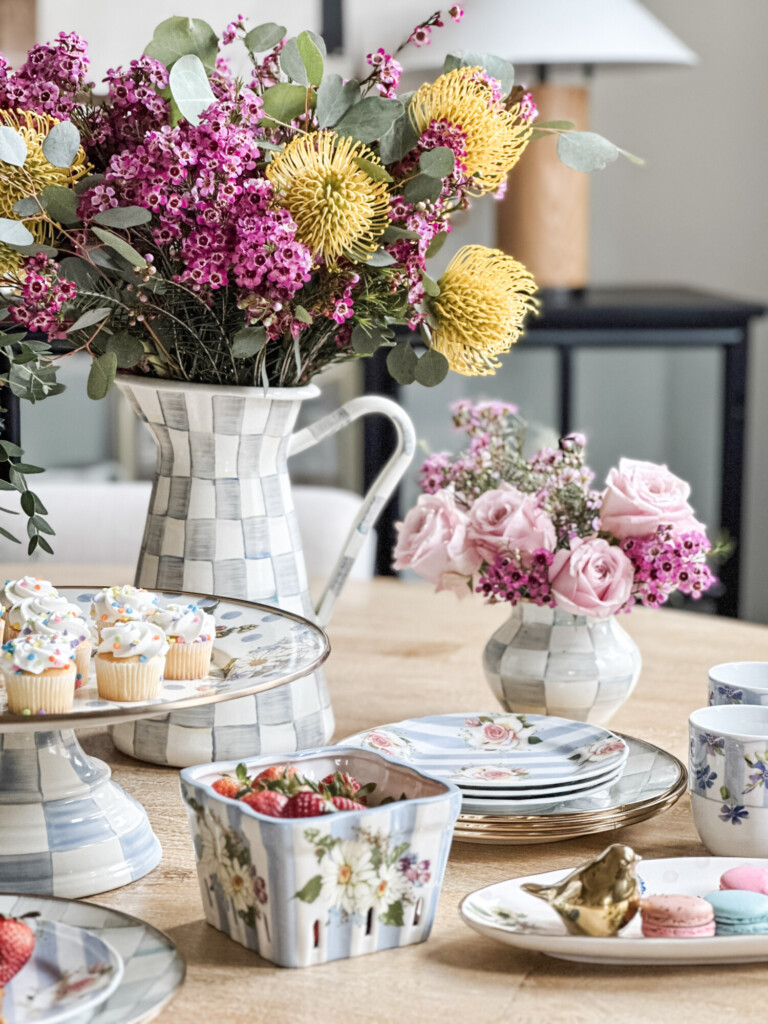 Festive tabletop styled with floral ceramics, serving dishes, and fresh flowers for entertaining and Mackenzie Childs