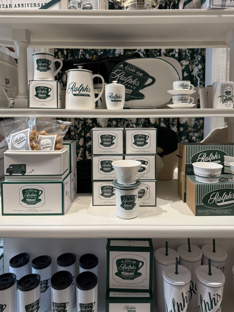 Ralph Lauren coffee mugs and accessories displayed on white shelving for a cozy coffee moment